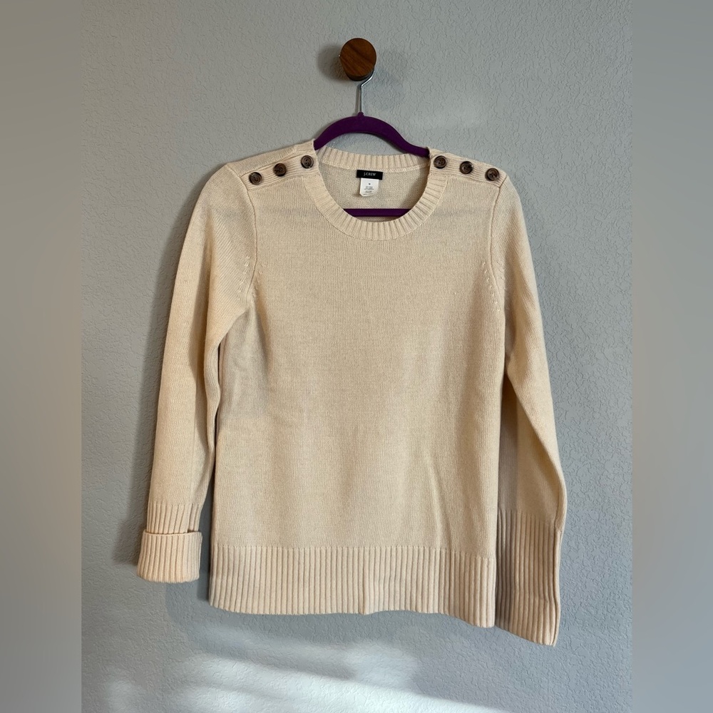 J. Crew. M. Cream sweater with button accents. Great condition.
